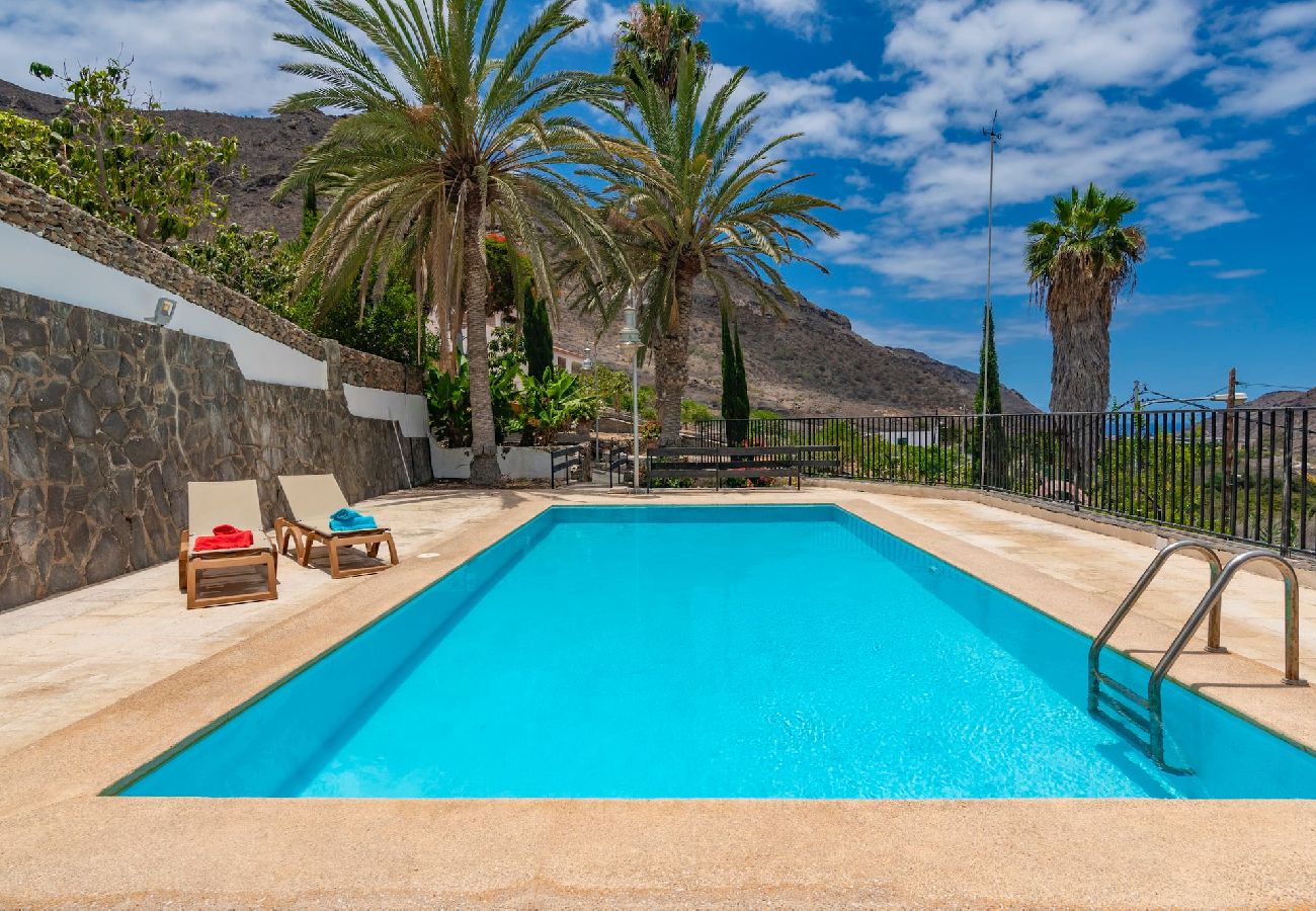 Huis in Mogán - GC0284 Vakantiehuis met gedeeld zwembad in Mogán