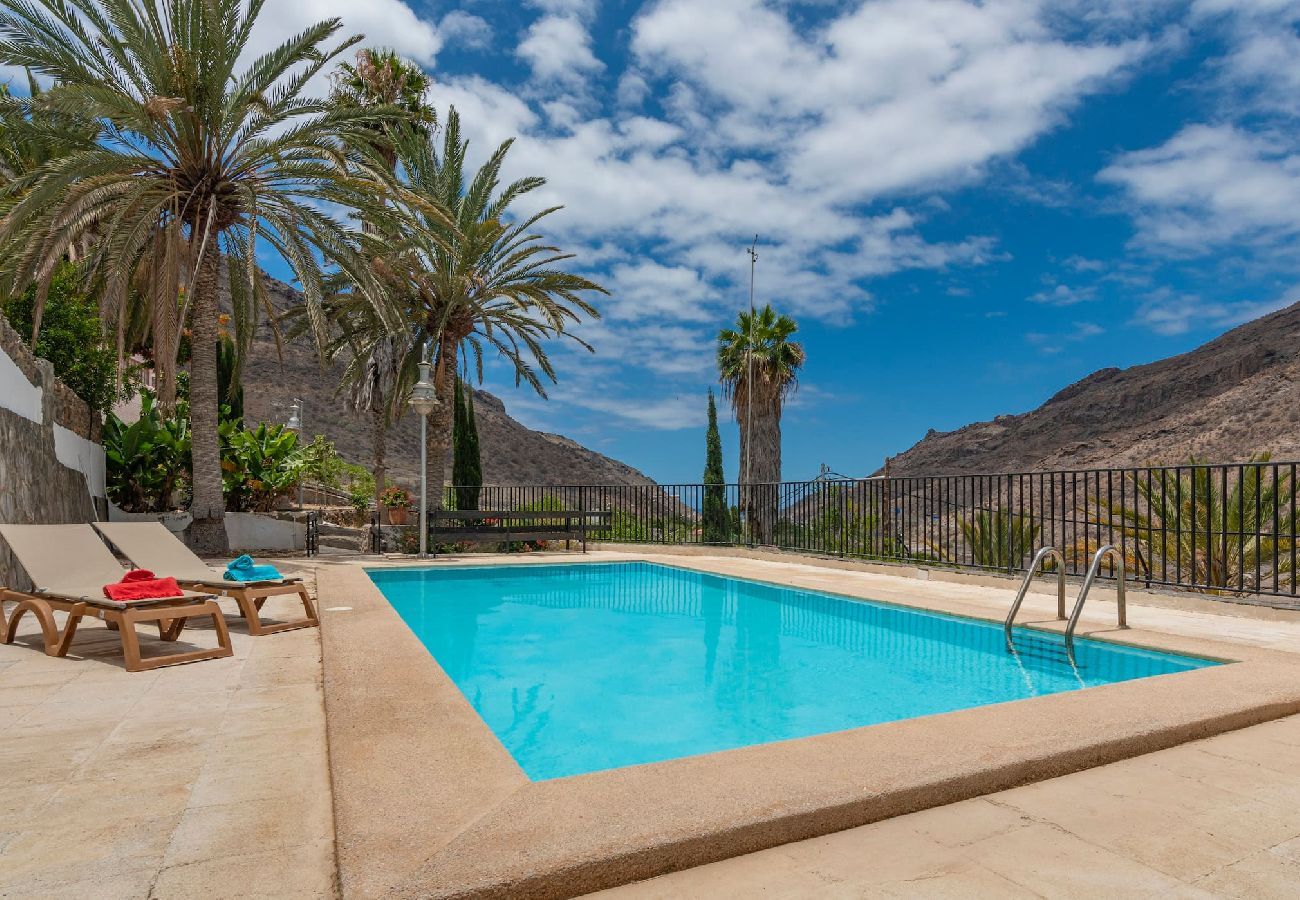 Huis in Mogán - GC0284 Vakantiehuis met gedeeld zwembad in Mogán